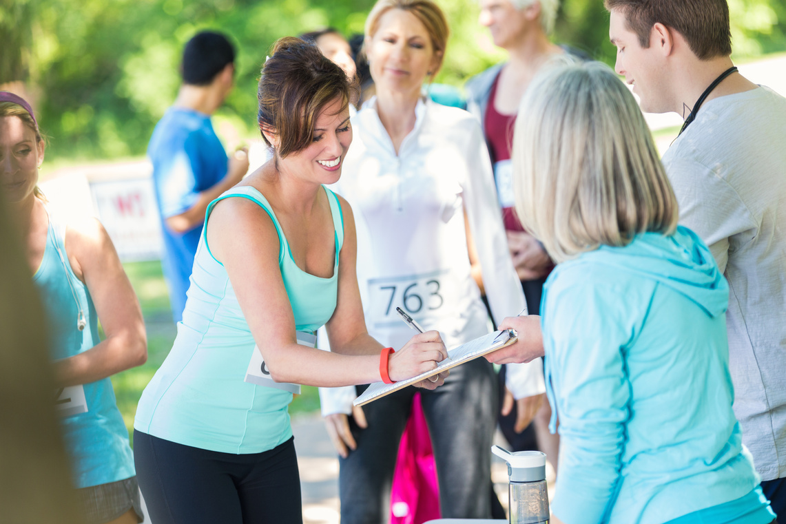 Woman signing up for marathon or 5k race fundraiser event